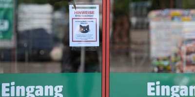 Baumarkt-Eingangstür mit Katzenschild