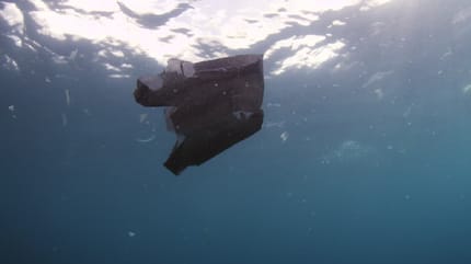 bolsa negra flotando en el mar