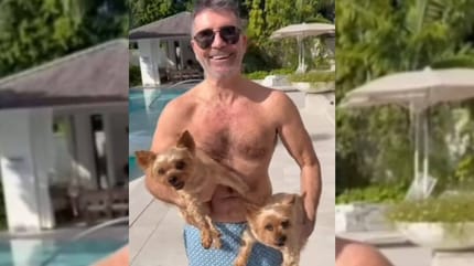 Simon Cowell holding two dogs