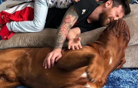 french mastiff cuddling with lionel messi and three children