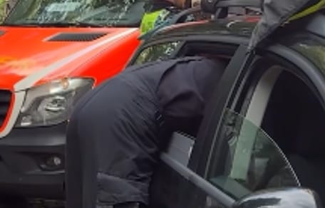 Feuerwehrmann lehnt sich ins Auto