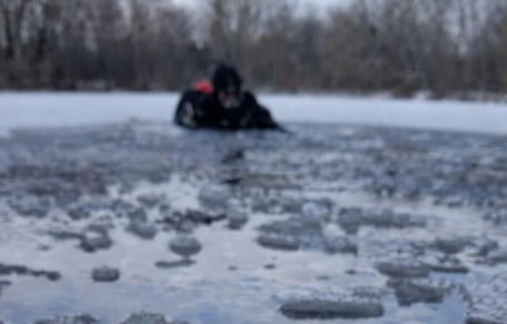 Diver in a frozen lake