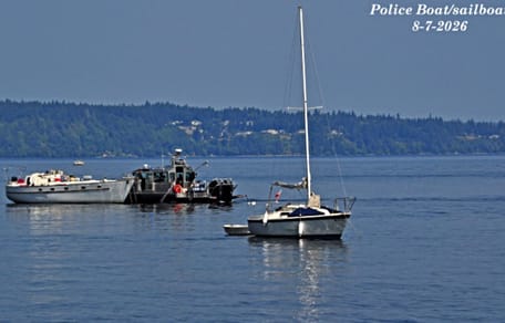 Polizeiboot legt neben Segelboot