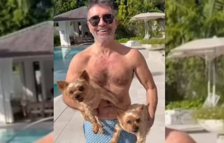 Simon Cowell holding two dogs