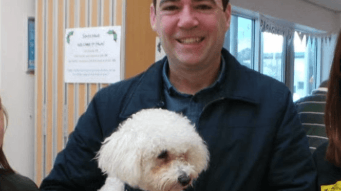 Andy Burnham holding his dog Axel