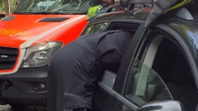 Feuerwehrmann lehnt sich ins Auto