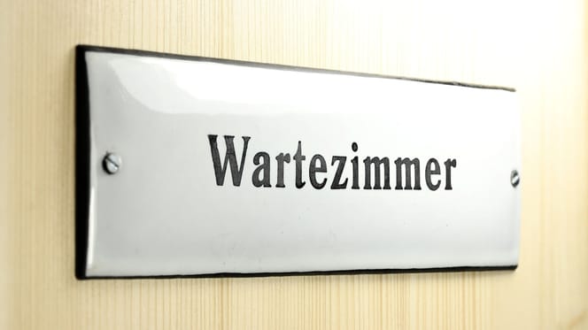 Door with waiting room sign