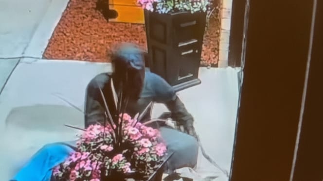 A man settling down in front of a veterinary clinic to save his dog